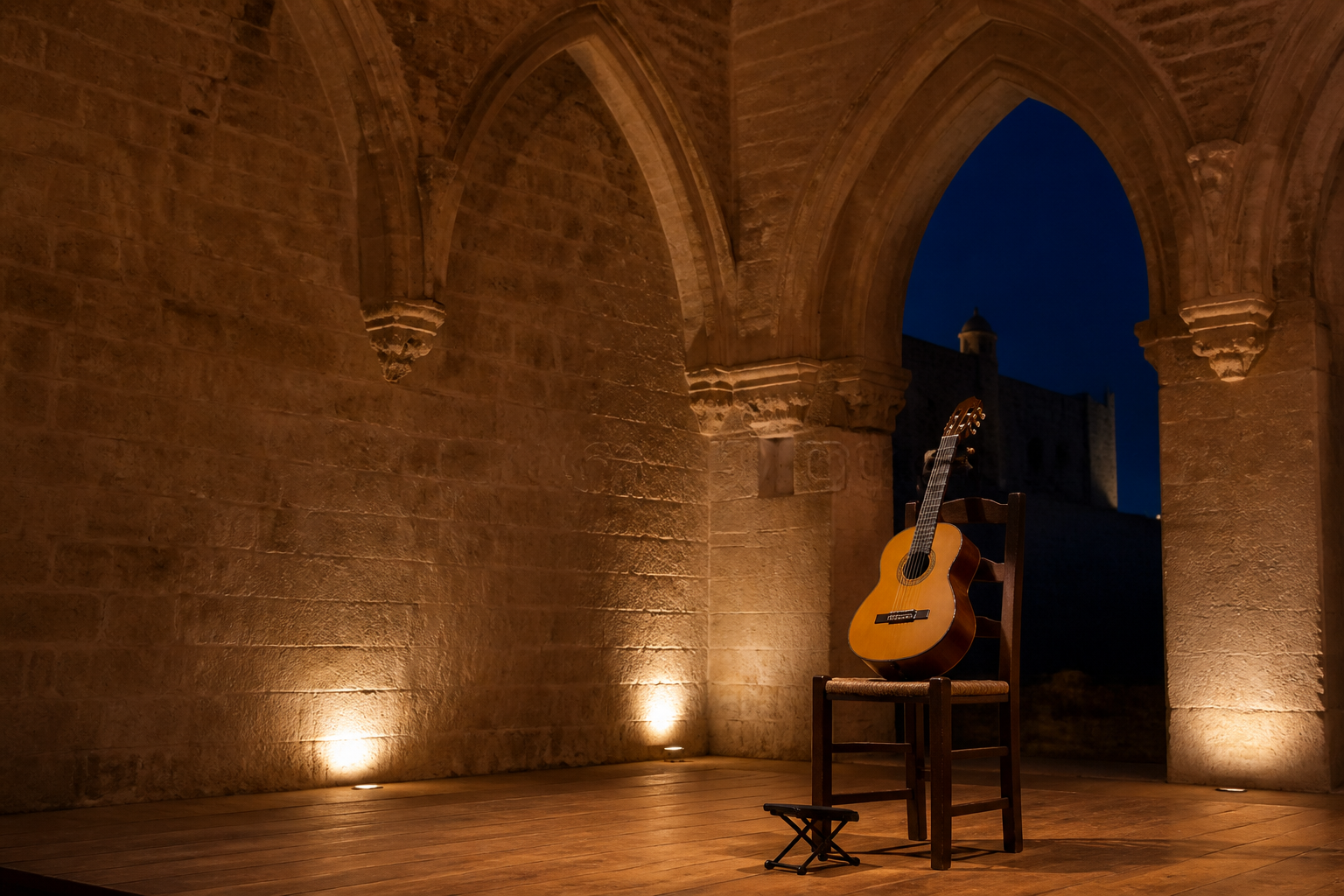 Guitarra clásica preparada en un salón histórico de piedra